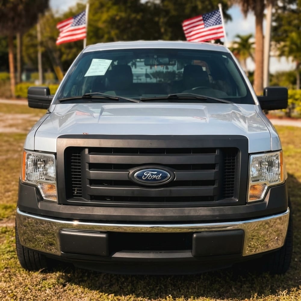 Ford F-150 on the FloridaCarHub lot in Pompano Beach, flags flying behind it